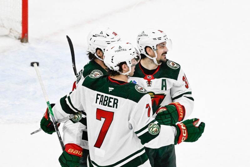 Mar 17, 2026; Chicago, Illinois, USA;  Minnesota Wild right wing Mats Zuccarello (36) celebrates with left wing Marcus Johansson (90) and  defenseman Brock Faber (7) after scoring a game winning goal during the overtime period against the Chicago Blackhawks at United Center. Mandatory Credit: Matt Marton-Imagn Images
