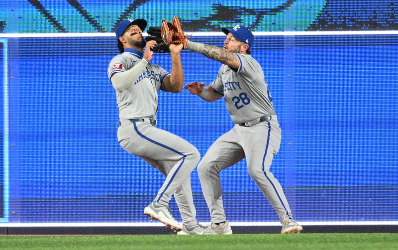 Apr 29, 2024; Toronto, Ontario, CAN; Kansas City Royals left fielder MJ Melendez (1) and center Kyle Isbel (28) collide as they pursue a fly ball hit by Toronto Blue Jays shortstop Isiah Kiner-Falefa (not shown) in the seventh inning at Rogers Centre. Melendez made the catch. Mandatory Credit: Dan Hamilton-USA TODAY Sports