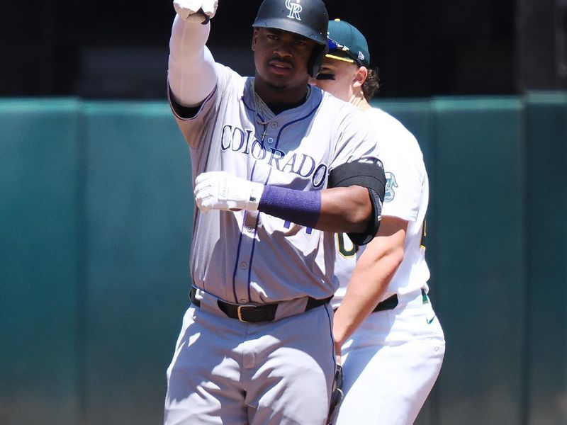 May 23, 2024; Oakland, California, USA; Oakland Athletics first baseman (44) gestures towards teammates ahead of Oakland Athletics second baseman Zack Gelof (20) after hitting a double during the first inning at Oakland-Alameda County Coliseum. Mandatory Credit: Kelley L Cox-USA TODAY Sports