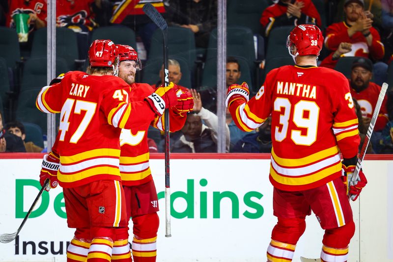 Sep 28, 2024; Calgary, Alberta, CAN; Calgary Flames center Blake Coleman (20) celebrates his goal with teammates against the Vancouver Canucks during the second period at Scotiabank Saddledome. Mandatory Credit: Sergei Belski-Imagn Images