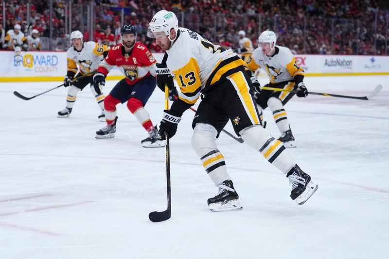 Jan 3, 2025; Sunrise, Florida, USA; Pittsburgh Penguins right wing Kevin Hayes (13) shoots the puck against the Florida Panthers during the second period at Amerant Bank Arena. Mandatory Credit: Rich Storry-Imagn Images