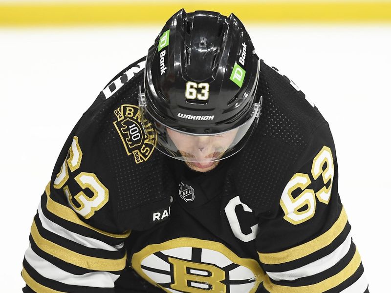 Feb 6, 2024; Boston, Massachusetts, USA; Boston Bruins left wing Brad Marchand (63) kneels on the ice after getting cross checked in the face by Calgary Flames center Martin Pospisil (76) (not pictured) during the first period at TD Garden. Mandatory Credit: Bob DeChiara-USA TODAY Sports