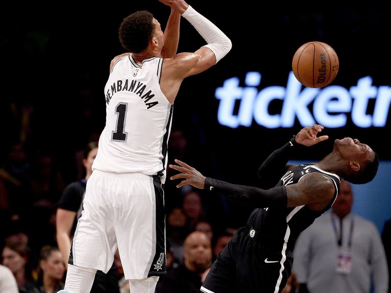 NEW YORK, NEW YORK - FEBRUARY 10: Victor Wembanyama #1 of the San Antonio Spurs collides with Dennis Schroder #17 of the Brooklyn Nets in the second half at Barclays Center on February 10, 2024 in the Brooklyn borough of New York City. The Brooklyn Nets defeated the San Antonio Spurs 123-103. NOTE TO USER: User expressly acknowledges and agrees that, by downloading and or using this photograph, User is consenting to the terms and conditions of the Getty Images License Agreement. (Photo by Elsa/Getty Images)