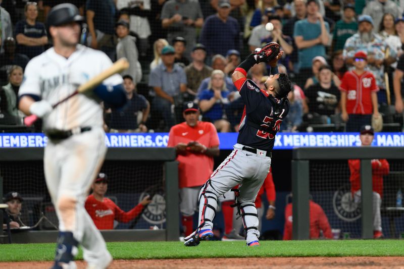 Jun 27, 2023; Seattle, Washington, USA; Washington Nationals catcher Keibert Ruiz (20) catches a fly ball hit by Seattle Mariners first baseman Ty France (23) during the tenth inning at T-Mobile Park. Mandatory Credit: Steven Bisig-USA TODAY Sports