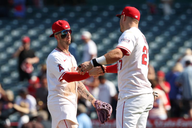 Sep 10, 2025; Anaheim, California, USA; Los Angeles Angels shortstop Zach Neto (left) celebrates a win with designated hitter Mike Trout (right) after defeating the Minnesota Twins 4-3 at Angel Stadium. Mandatory Credit: Kiyoshi Mio-Imagn Images