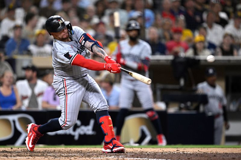 Aug 20, 2024; San Diego, California, USA; Minnesota Twins catcher Christian Vazquez (8) hits a two-RBI single against the San Diego Padres during the eighth inning at Petco Park. Mandatory Credit: Orlando Ramirez-USA TODAY Sports