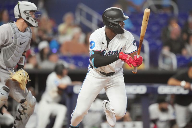 May 2, 2024; Miami, Florida, USA;  Miami Marlins right fielder Jesús Sánchez (12) hits a single in the tenth inning to win the game against the Colorado Rockies at loanDepot Park. Mandatory Credit: Jim Rassol-USA TODAY Sports