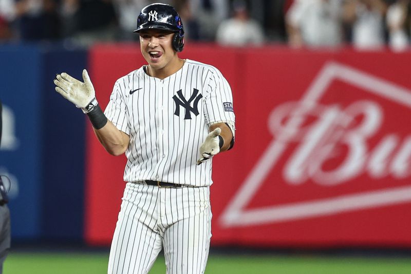 Jul 3, 2024; Bronx, New York, USA; New York Yankees shortstop Anthony Volpe (11) celebrates after hitting a two run double in the seventh inning against the Cincinnati Reds at Yankee Stadium. Mandatory Credit: Wendell Cruz-USA TODAY Sports