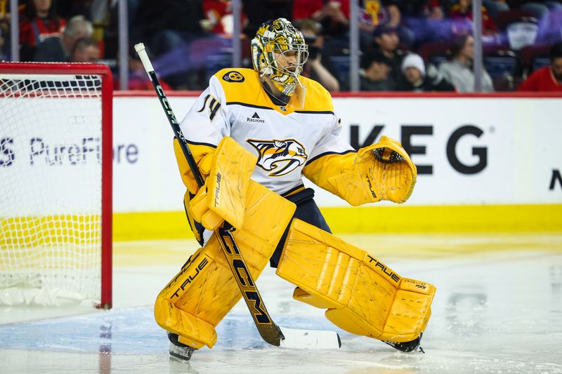 Nov 15, 2024; Calgary, Alberta, CAN; Nashville Predators goaltender Juuse Saros (74) guards his net against the Calgary Flames during the second period at Scotiabank Saddledome. Mandatory Credit: Sergei Belski-Imagn Images