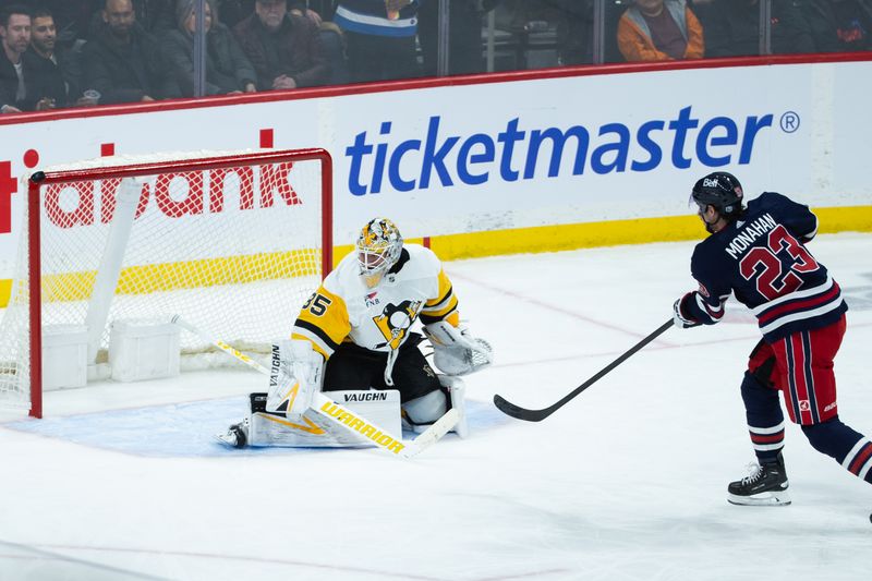 Feb 10, 2024; Winnipeg, Manitoba, CAN;  Winnipeg Jets forward Sean Monahan (23) shoots wide of Pittsburgh Penguins goalie Tristan Jarry (35) during the third period at Canada Life Centre. Mandatory Credit: Terrence Lee-USA TODAY Sports