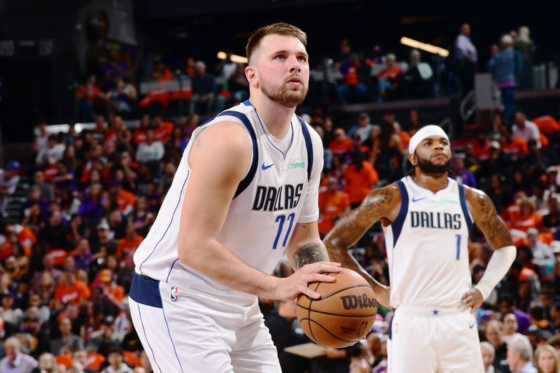 PHOENIX, AZ - OCTOBER  26: Luka Doncic #77 of the Dallas Mavericks shoots a free throw during the game against the Phoenix Suns on October 26, 2024 at Footprint Center in Phoenix, Arizona. NOTE TO USER: User expressly acknowledges and agrees that, by downloading and or using this photograph, user is consenting to the terms and conditions of the Getty Images License Agreement. Mandatory Copyright Notice: Copyright 2024 NBAE (Photo by Kate Frese/NBAE via Getty Images)