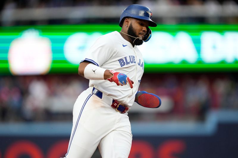 Jul 26, 2024; Toronto, Ontario, CAN; Toronto Blue Jays first baseman Vladimir Guerrero Jr. (27) runs to home to score on a double hit by second baseman Spencer Horwitz (not pictured) during first inning against the Texas Rangers at Rogers Centre. Mandatory Credit: John E. Sokolowski-USA TODAY Sports