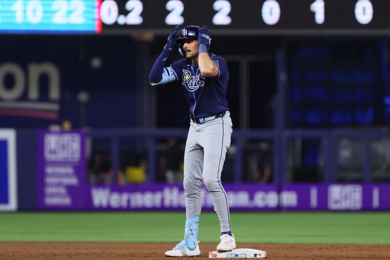 Jun 5, 2024; Miami, Florida, USA; Tampa Bay Rays center fielder Josh Lowe (15) reacts from second base after hitting an RBI double against the Miami Marlins during the first inning at loanDepot Park. Mandatory Credit: Sam Navarro-USA TODAY Sports