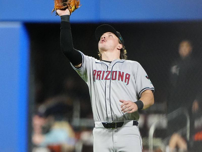 May 31, 2024; New York City, New York, USA; Arizona Diamondbacks right fielder Jake McCarthy (31) catches a fly ball hit by New York Mets third baseman Mark Vientos (not pictured) during the eighth inning at Citi Field. Mandatory Credit: Gregory Fisher-USA TODAY Sports