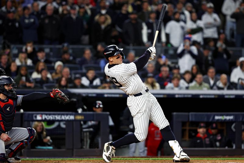 Oct 15, 2024; Bronx, New York, USA; New York Yankees outfielder Aaron Judge (99) hits a two run home run during the seventh inning against the Cleveland Guardians in game two of the ALCS for the 2024 MLB Playoffs at Yankee Stadium. Mandatory Credit: Wendell Cruz-Imagn Images