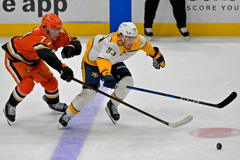 Jan 25, 2025; Anaheim, California, USA; Anaheim Ducks right wing Frank Vatrano (77) and Nashville Predators defenseman Adam Wilsby (83) go for the puck in the third period at Honda Center. Mandatory Credit: Jayne Kamin-Oncea-Imagn Images