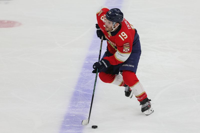 Feb 27, 2024; Sunrise, Florida, USA; Florida Panthers left wing Matthew Tkachuk (19) moves the puck against the Buffalo Sabres during the third period at Amerant Bank Arena. Mandatory Credit: Sam Navarro-USA TODAY Sports