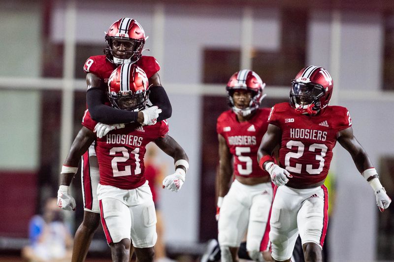 Sep 2, 2022; Bloomington, Indiana, USA; Indiana Hoosiers defensive back Noah Pierre (21) celebrates his fumble recovery with teammates in the second half against the Illinois Fighting Illini at Memorial Stadium. Mandatory Credit: Trevor Ruszkowski-USA TODAY Sports