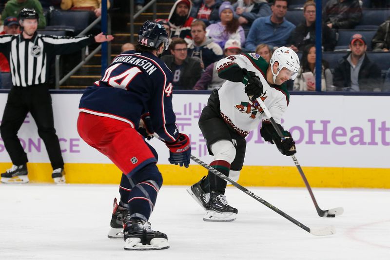 Nov 16, 2023; Columbus, Ohio, USA; Arizona Coyotes right wing Jason Zucker (16) wrists a shot on goal as Columbus Blue Jackets defenseman Erik Gudbranson (44) defends during the third period at Nationwide Arena. Mandatory Credit: Russell LaBounty-USA TODAY Sports