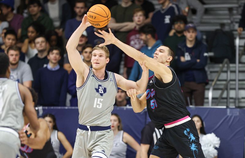 Jan 24, 2024; Houston, Texas, USA; Florida Atlantic Owls center Vladislav Goldin (50) defends against Rice Owls forward Max Fiedler (15) during the first half at Tudor Fieldhouse. Mandatory Credit: Troy Taormina-USA TODAY Sports