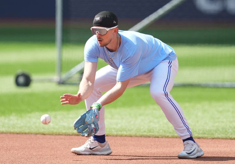 Jun 29, 2023; Toronto, Ontario, CAN; Toronto Blue Jays second baseman Cavan Biggio (8) fields balls during batting practice against the San Francisco Giants at Rogers Centre. Mandatory Credit: Nick Turchiaro-USA TODAY Sports