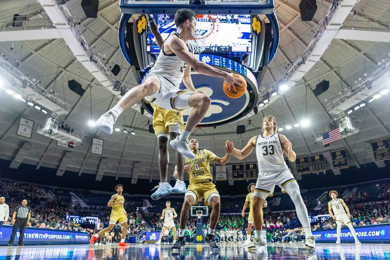 Feb 14, 2026; South Bend, Indiana, USA; Notre Dame Fighting Irish guard Logan Imes (2) leaps and passes to forward Carson Towt (33) against the Georgia Tech Yellow Jackets during the second half at Purcell Pavilion at the Joyce Center. Mandatory Credit: Michael Caterina-Imagn Images