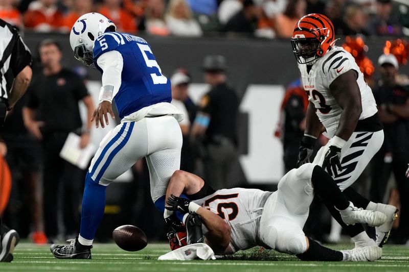 Indianapolis Colts quarterback Anthony Richardson (5) fumbles as he is tackled by Cincinnati Bengals defensive end Justin Blazek (51) during the first half of a preseason NFL football game, Thursday, Aug. 22, 2024, in Cincinnati. (AP Photo/Carolyn Kaster)