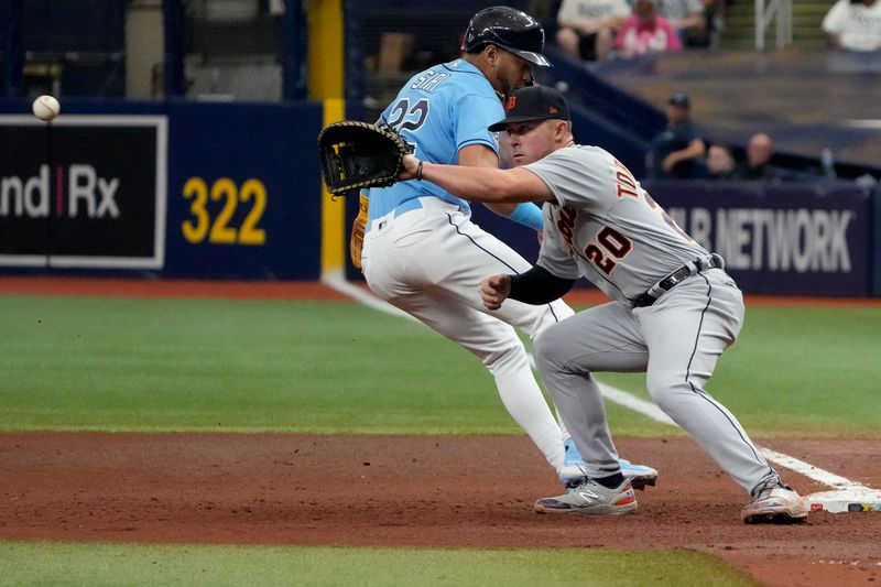 Apr 2, 2023; St. Petersburg, Florida, USA; Tampa Bay Rays center fielder Jose Siri (22) gets back to first safely as Detroit Tigers first baseman Spencer Torkelson (20) tries to make the tag during the sixth inning at Tropicana Field. Mandatory Credit: Dave Nelson-USA TODAY Sports