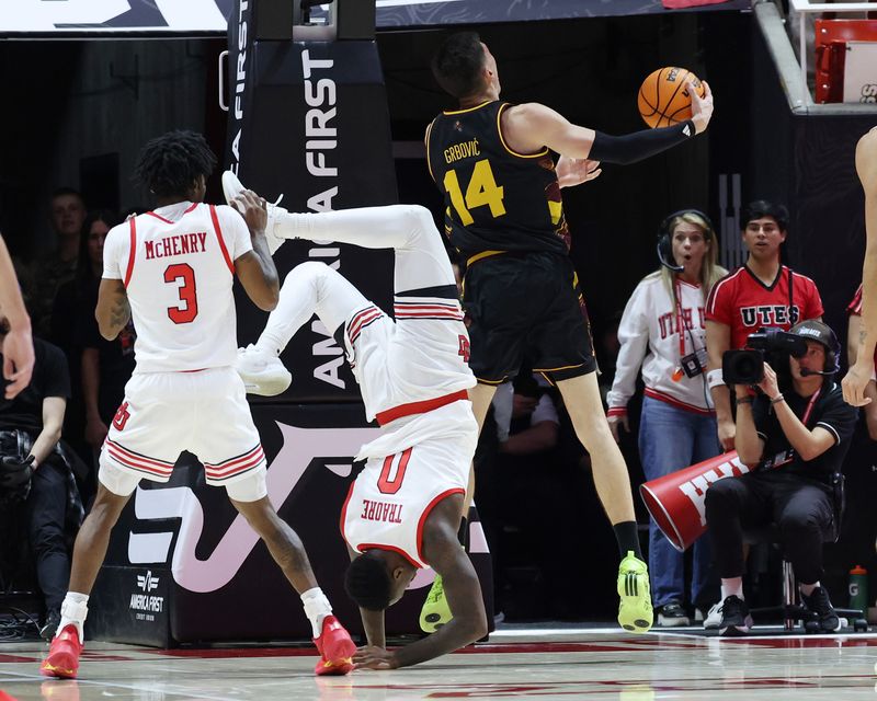 Feb 4, 2026; Salt Lake City, Utah, USA; Utah Utes forward Seydou Traore (0) goes to the floor after a play against Arizona State Sun Devils forward Andrija Grbovic (14) during the second half at Jon M. Huntsman Center. Mandatory Credit: Rob Gray-Imagn Images