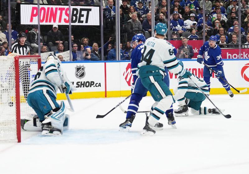 Jan 9, 2024; Toronto, Ontario, CAN; Toronto Maple Leafs center Auston Matthews (34) scores a goal against the San Jose Sharks during the first period at Scotiabank Arena. Mandatory Credit: Nick Turchiaro-USA TODAY Sports