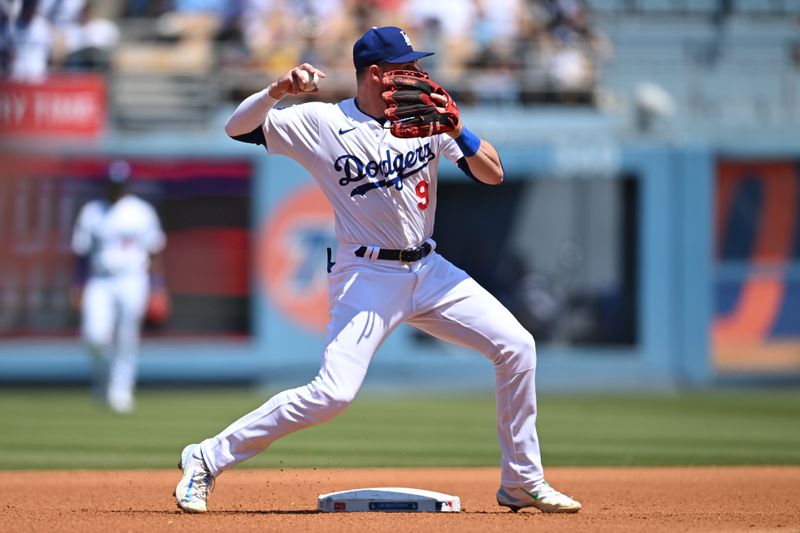 Apr 21, 2024; Los Angeles, California, USA; Los Angeles Dodgers second baseman Gavin Lux (9) throws to first against the New York Mets during the third inning at Dodger Stadium. Mandatory Credit: Jonathan Hui-USA TODAY Sports