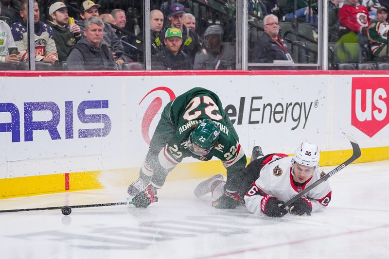 Apr 2, 2024; Saint Paul, Minnesota, USA; Minnesota Wild center Marat Khusnutdinov (22) and Ottawa Senators defenseman Erik Brannstrom (26) skate after the puck in the second period at Xcel Energy Center. Mandatory Credit: Brad Rempel-USA TODAY Sports