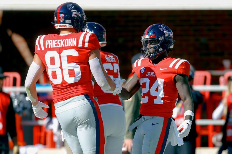 Nov 18, 2023; Oxford, Mississippi, USA; Mississippi Rebels tight end Caden Prieskorn (86) and running back Ulysses Bentley IV (24) react after a touchdown during the first half against the Louisiana Monroe Warhawks at Vaught-Hemingway Stadium. Mandatory Credit: Petre Thomas-USA TODAY Sports