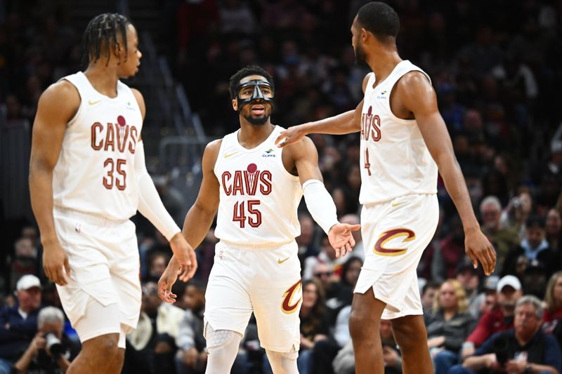 CLEVELAND, OHIO - MARCH 29: (L-R) Isaac Okoro #35, Donovan Mitchell #45 and Evan Mobley #4 of the Cleveland Cavaliers celebrate during the first half against the Philadelphia 76ers at Rocket Mortgage Fieldhouse on March 29, 2024 in Cleveland, Ohio. NOTE TO USER: User expressly acknowledges and agrees that, by downloading and or using this photograph, User is consenting to the terms and conditions of the Getty Images License Agreement. (Photo by Jason Miller/Getty Images)