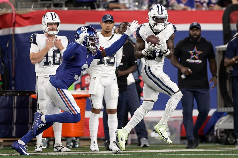 Dallas Cowboys wide receiver CeeDee Lamb (88) makes a catch against New York Giants cornerback Deonte Banks (3) on his way to a touchdown during the second quarter of an NFL football game, Thursday, Sept. 26, 2024, in East Rutherford, N.J. (AP Photo/Adam Hunger)