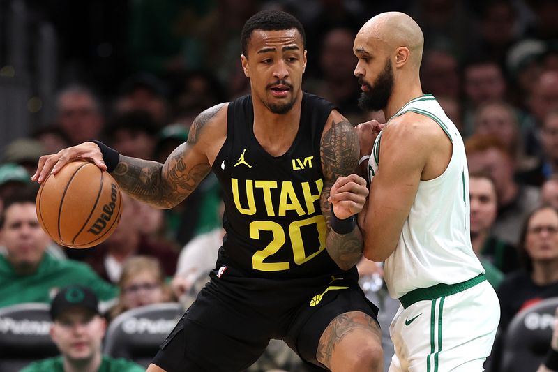 BOSTON, MASSACHUSETTS - JANUARY 05: Derrick White #9 of the Boston Celtics defends John Collins #20 of the Utah Jazz during the first quarter at TD Garden on January 05, 2024 in Boston, Massachusetts. NOTE TO USER: User expressly acknowledges and agrees that, by downloading and or using this photograph, user is consenting to the terms and conditions of the Getty Images License Agreement.  (Photo by Maddie Meyer/Getty Images)