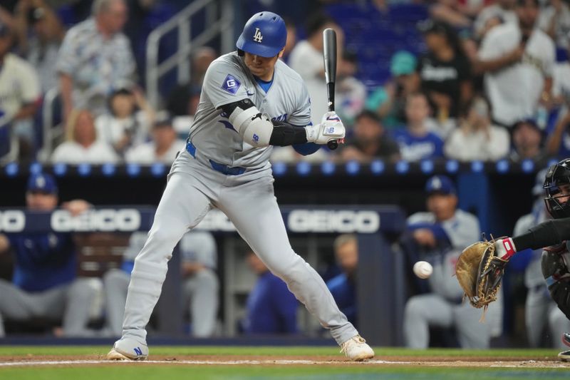 Sep 17, 2024; Miami, Florida, USA;  Los Angeles Dodgers designated hitter Shohei Ohtani (17) takes strike three in the first inning against the Miami Marlins at loanDepot Park. Mandatory Credit: Jim Rassol-Imagn Images