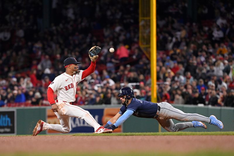 May 16, 2024; Boston, Massachusetts, USA;  Tampa Bay Rays shortstop Jose Caballero (7) is tagged out by Boston Red Sox shortstop Ceddanne Rafaela (43) while trying to steal second base during the sixth inning at Fenway Park. Mandatory Credit: Eric Canha-USA TODAY Sports