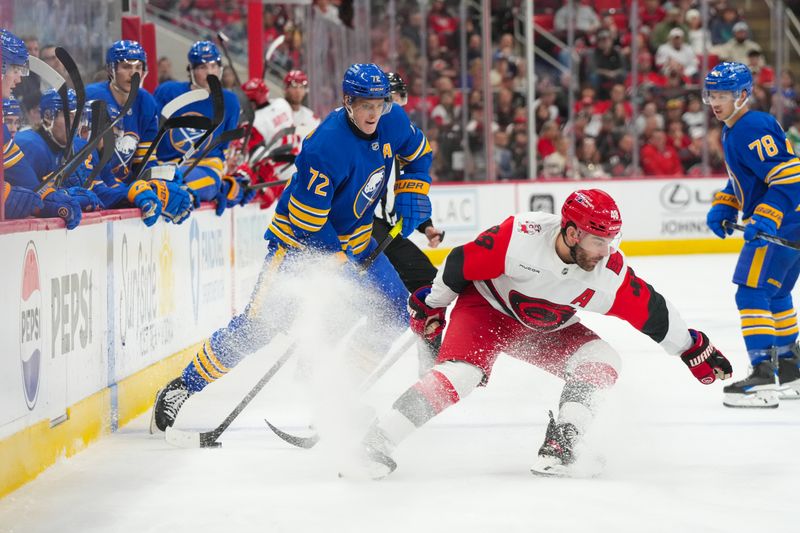 Nov 8, 2025; Raleigh, North Carolina, USA;  Buffalo Sabres center Tage Thompson (72) skates with the puck against Carolina Hurricanes left wing Jordan Martinook (48) during the second period at Lenovo Center. Mandatory Credit: James Guillory-Imagn Images