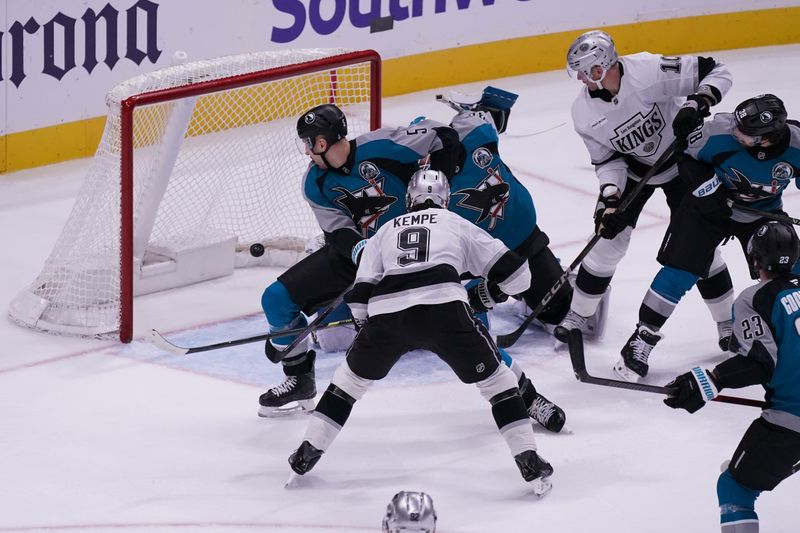 Nov 20, 2025; San Jose, California, USA;  Los Angeles Kings right winger Adrian Kempe (9) scores a goal through San Jose Sharks defenseman Vincent Desharnais (5) and San Jose Sharks goaltender Yaroslav Askarov (30)  during the third period at SAP Center at San Jose. Los Angeles Kings right winger Corey Perry (10), San Jose Sharks defenseman Mario Ferraro (38), and center Barclay Goodrow (23) look on. Mandatory Credit: David Gonzales-Imagn Images