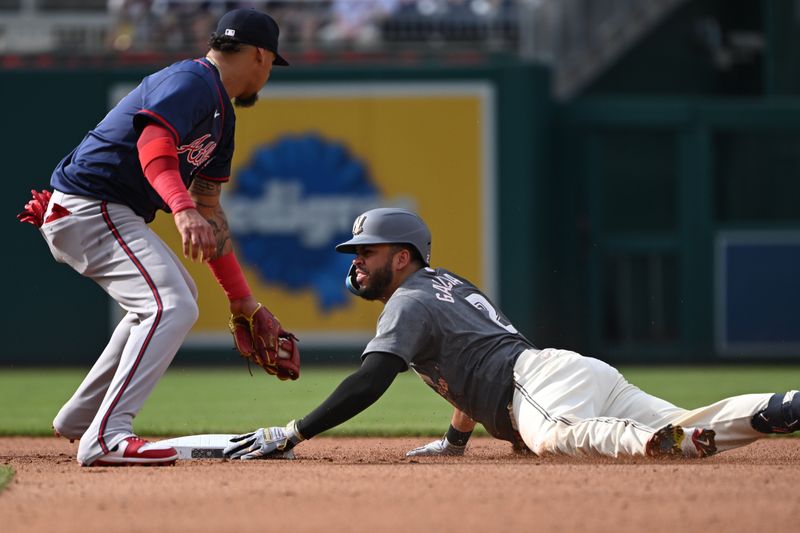 Jun 8, 2024; Washington, District of Columbia, USA; Washington Nationals second baseman Luis Garcia Jr. (2) dives into second base in front of Atlanta Braves shortstop Orlando Arcia (11) during the fourth inning at Nationals Park. Mandatory Credit: Rafael Suanes-USA TODAY Sports