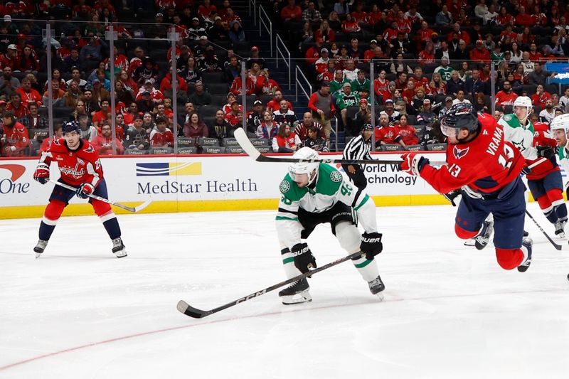 Oct 17, 2024; Washington, District of Columbia, USA; Washington Capitals left wing Jakub Vrana (13) loses his balance while shooting the puck as Dallas Stars defenseman Ilya Lyubushkin (46) in the third period at Capital One Arena. Mandatory Credit: Geoff Burke-Imagn Images