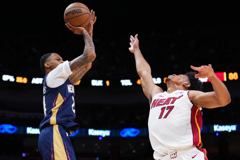 MIAMI, FLORIDA - OCTOBER 13: Jordan Hawkins #24 of the New Orleans Pelicans goes up for a shot against Zyon Pullin #17 of the Miami Heat during the fourth quarter of a preseason game at Kaseya Center on October 13, 2024 in Miami, Florida. NOTE TO USER: User expressly acknowledges and agrees that, by downloading and or using this photograph, User is consenting to the terms and conditions of the Getty Images License Agreement. (Photo by Rich Storry/Getty Images)