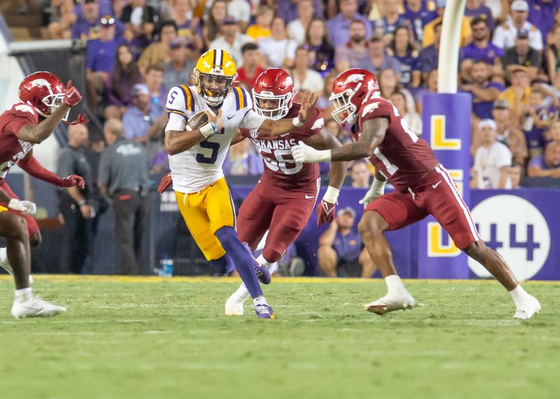 Sep 23, 2023; Baton Rouge, Louisiana, USA; LSU Tigers quarterback Jayden Daniels (5) runs the ball during the game against the Arkansas Razorbacks at Tiger Stadium. Mandatory Credit: Scott Clause-USA TODAY Sports