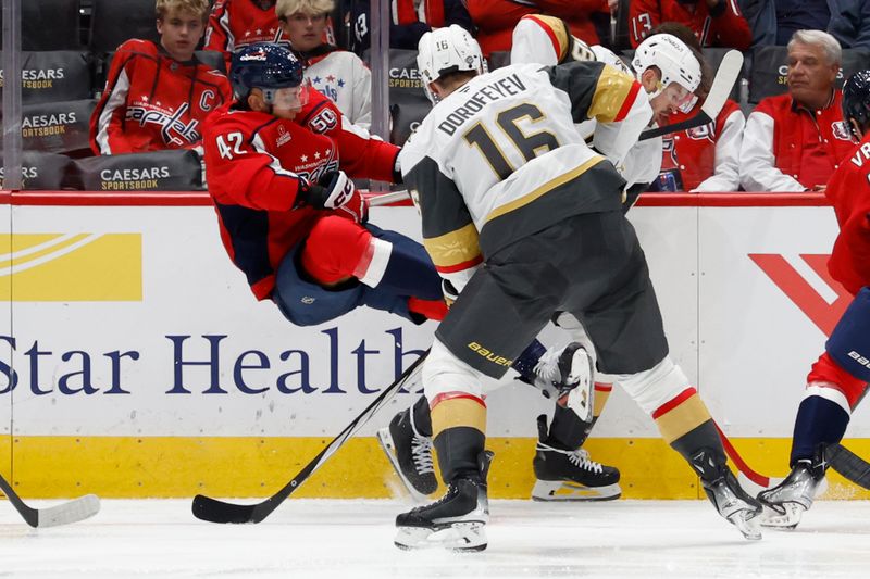 Oct 15, 2024; Washington, District of Columbia, USA; Washington Capitals defenseman Martin Fehervary (42) is checked by Vegas Golden Knights center Tomas Hertl (48) while battling for the puck in the second period at Capital One Arena. Mandatory Credit: Geoff Burke-Imagn Images