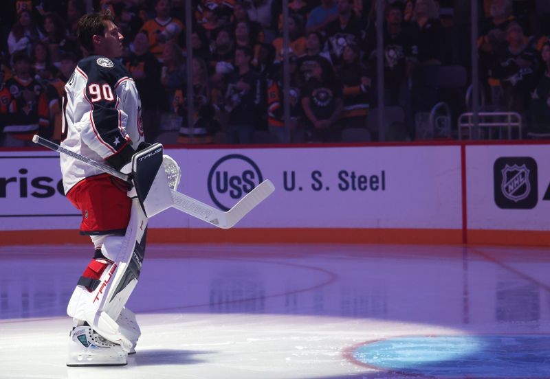 Sep 27, 2025; Pittsburgh, Pennsylvania, USA;  Columbus Blue Jackets goaltender Elvis Merzlikins (90) stands for the national anthem against the Pittsburgh Penguins at PPG Paints Arena. Mandatory Credit: Charles LeClaire-Imagn Images