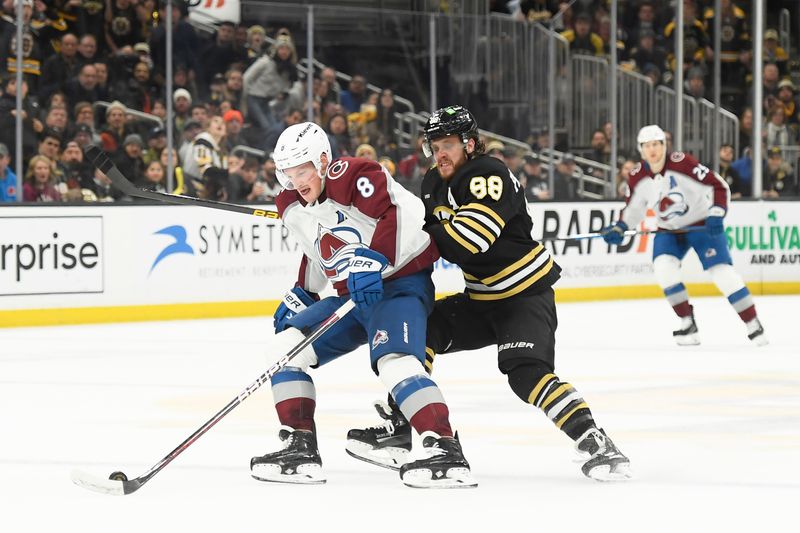 Jan 18, 2024; Boston, Massachusetts, USA; Colorado Avalanche defenseman Cale Makar (8) controls the puck from Boston Bruins right wing David Pastrnak (88) during the third period at TD Garden. Mandatory Credit: Bob DeChiara-USA TODAY Sports