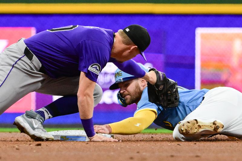 Sep 6, 2024; Milwaukee, Wisconsin, USA; Milwaukee Brewers first baseman Jake Bauers (9) steals second base before tag by Colorado Rockies second baseman Aaron Schunk (30) in the second inning at American Family Field. Mandatory Credit: Benny Sieu-Imagn Images