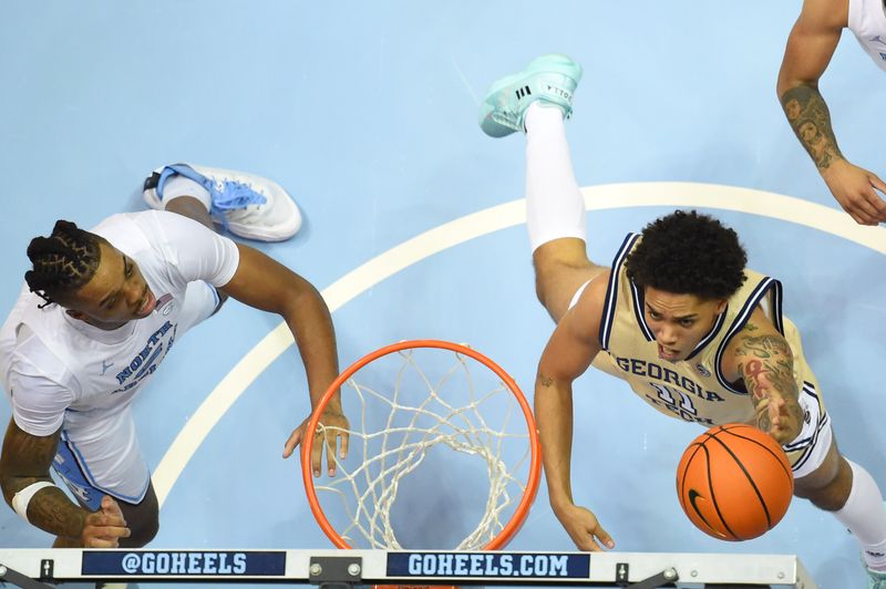 Dec 10, 2022; Chapel Hill, North Carolina, USA; Georgia Tech Yellow Jackets guard Tristan Maxwell (11) shoots as North Carolina Tar Heels forward Armando Bacot (5) defends in the second half at Dean E. Smith Center. Mandatory Credit: Bob Donnan-USA TODAY Sports