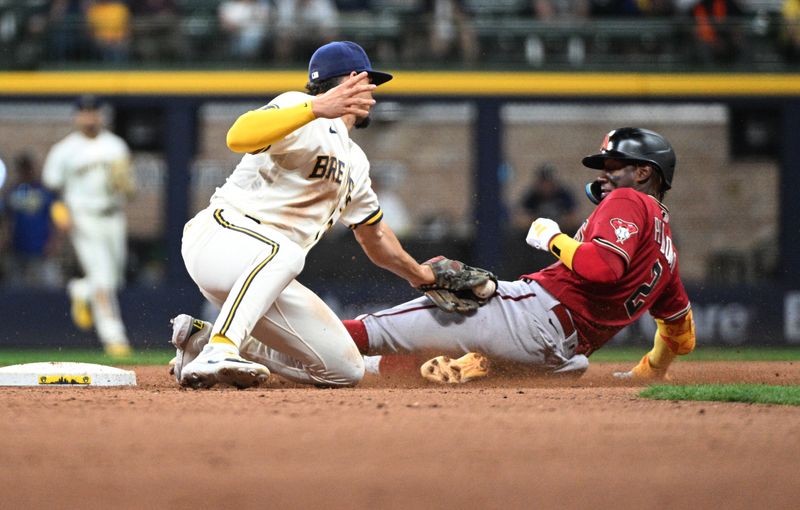 Jun 20, 2023; Milwaukee, Wisconsin, USA; Milwaukee Brewers shortstop Willy Adames (27) tags out Arizona Diamondbacks shortstop Geraldo Perdomo (2) for the final out of the game at American Family Field. Milwaukee Brewers 7 Arizona Diamondbacks 5. Mandatory Credit: Michael McLoone-USA TODAY Sports